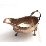 George III small Silver Sauce Boat, looped handle, plain body raised on three swept legs, with shell