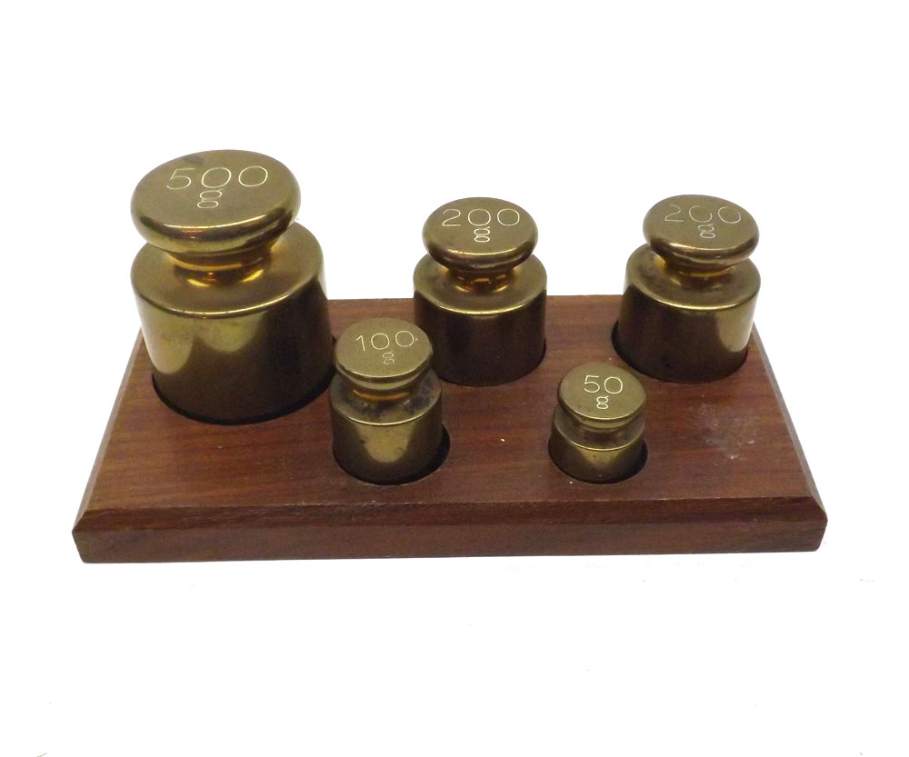 Graduated set of five Brass weights from 500 to 50gms on a fitted hardwood stand