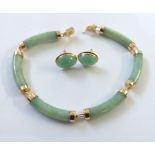 A  yellow metal  and jade bracelet and matching earrings