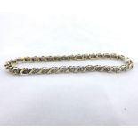Hallmarked 9ct Gold Tennis (or Line) Bracelet, each leaf shaped articulated panel set with a small