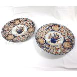 Pair of Imari circular plates, the centres decorated in traditional colours with Jardinihres of