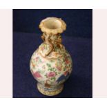 A 19th Century Famille Rose Baluster Vase, (stained), the neck applied with lizards and exotic birds