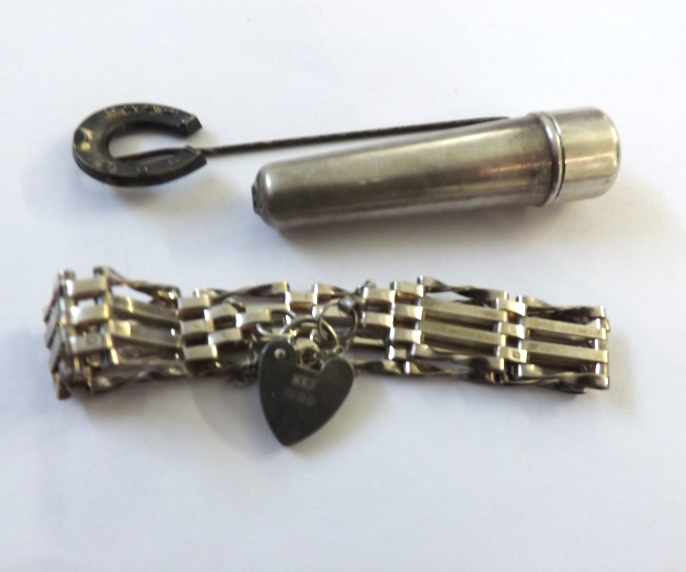 A Mixed Group comprising: a hallmarked Silver Four Bar Gate Bracelet with padlock; a hallmarked