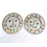 A pair of 18th Century Chinese Plates, of circular form, painted predominantly in iron red and