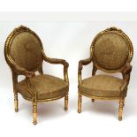 Pair of giltwood Armchairs with floral carved frames, upholstered in green floral fabric, raised