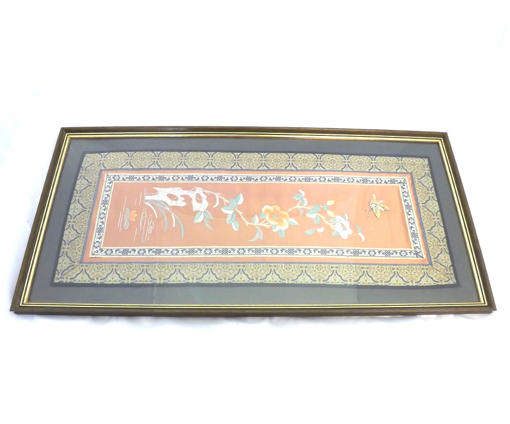 An Oriental Silk Framed Mandarin Sleeve, embroidered with central panel of butterfly and foliage,