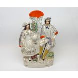 A 19th Century Staffordshire flat-back Spill Vase modelled as an agricultural couple astride a