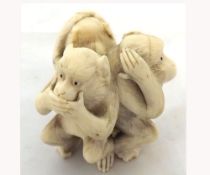 A Carved Ivory or Composition Netsuke formed as three wise monkeys (losses to feet etc and crack), 2