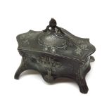 A WMF Pewter Dressing Table Trinket Box of serpentine form, the body decorated with stylised foliage
