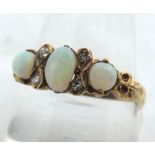 Unmarked Precious Metal ring, set with three Opals and four small brilliant cut Diamonds