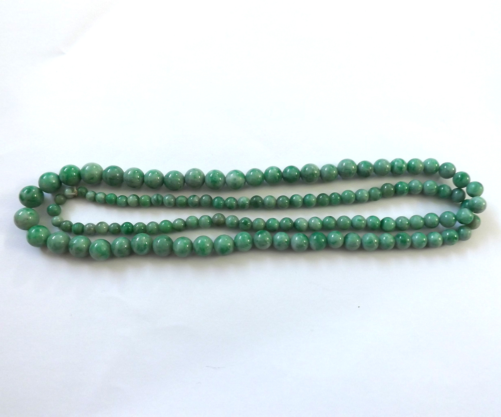 A string of Graduated Polished Jade Beads, 74cm long, the largest bead approx 9mm diameter