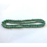 A string of Graduated Polished Jade Beads, 74cm long, the largest bead approx 9mm diameter