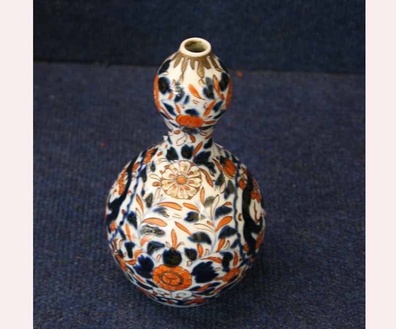 An Imari type Baluster Vase of double gourd form, decorated in traditional colours with scrolling