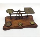 Set of vintage Postal Scales on a shaped wooden base, together with graduated set of weights, base