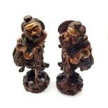 Pair of Oriental hardwood figures of old men with water pots and set with composition eyes, 11" high