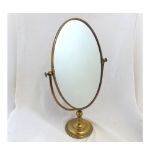 20th Century Brass framed oval swing dressing table Mirror, raised on a spreading circular foot, 22"
