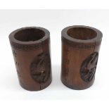 A pair of Oriental Carved Hardwood Cylinder Vases, carved with panels of exotic birds and figures