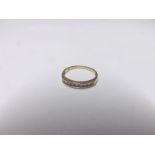 Hallmarked 18ct Gold Ring, channel set with nine small Brilliant Cut Diamonds