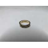 Hallmarked 9ct Gold Ring, the engraved front set with four small Sapphires and three small