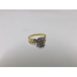 A high grade precious metal all small diamond set cluster Ring of flower head design, having chevron