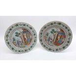 A pair of 18th Century Chinese Circular Plates, the centres painted in colours with mandarin