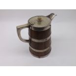 A late 19th or early 20th Century Oak and Silver Plated Jug of tapering circular form, 8 1/2" high