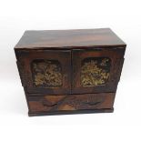 A Chinese Rosewood Simulated and Lacquered Table Top Cabinet, two doors with gilded panels enclosing