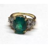 18ct Diamond and Emerald seven stone ring. Central emerald measuring 10mm x 8mm approx. 3 diamonds