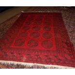 Shiraz carpet multi gulled border and central panel of lozenges, mainly dark red field with black
