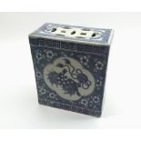 A Chinese Flower Brick, of rectangular form with pierced top, decorated with panels of Kaolin in