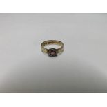 Early 20th Century hallmarked 9ct Gold Ring set with a single Amethyst, engraved shoulders,