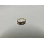 Early 20th Century 18ct Gold Ring, boat shaped panel featuring three small blue Sapphires and two