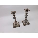 A pair of 19th Century Silver Plate on Copper Candlesticks, the tapering stems raised on spreading
