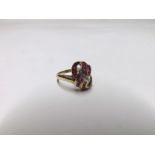 Hallmarked 9ct Gold Ring of double cross over design featuring rows of small square cut Rubies and