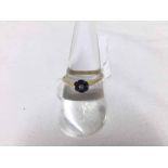 Hallmarked 18ct Gold ring, a flower head design panel set with six small dark blue Sapphires and a
