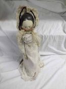 A late 19th/early 20th Century Wooden Doll with painted facial features, on five piece wooden