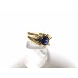 Gent s yellow metal ring, floral set with a blue stone, stamped 9K and weighing approx 8gms all in