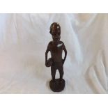 Ethnic African Hardwood carved figure of a man with a coconut on his hip, 10.5"  high