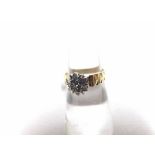 A high grade precious metal all small diamond set cluster Ring of flower head design, having chevron