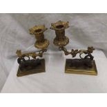 Pair of Bronze patinated and ormolu candlesticks, the bases applied with figures of dogs and with