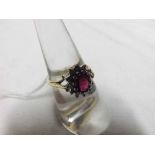 Hallmarked 18ct Gold centre Ruby and small brilliant cut Diamond surround Cluster Ring