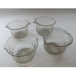 Grouped lot of four 19th Century clear glass wine coolers of circular form with star cut bases,