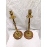 Pair of tall Brass candlesticks with urn formed sconces over plain drip trays, ring turned columns