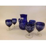 20th Century clear and blue glass Water Jug and six glasses all decorated with cut detail, 8" high