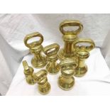 Graduated collection of seven various bell-shaped Brass weights, the largest from 1 Stone down to