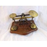 Set of Victorian Brass postal scales on a Mahogany serpentine base together with base stamped