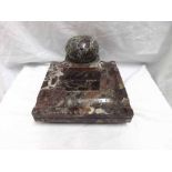 Veined marble inkstand of square form with central inkwell with domed cover, the stand carved with