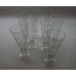 Set of eight 20th Century tapering glasses of circular form, raised on spreading bases, decorated