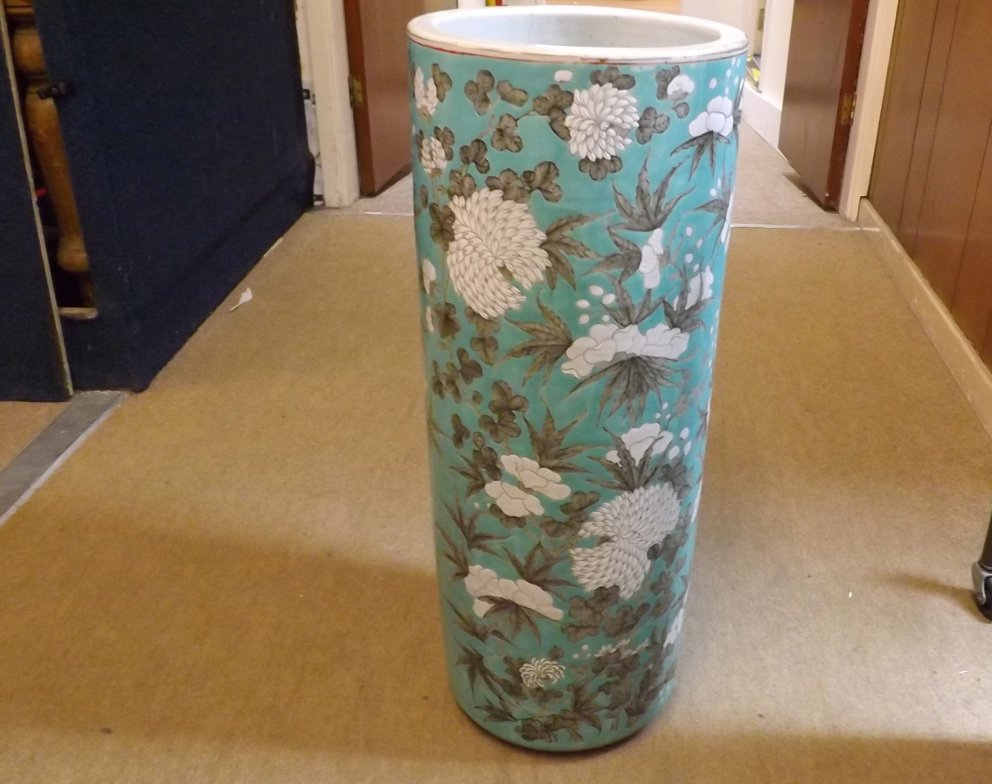 A Chinese cylindrical Stick Stand, painted in grey and white with all over flowering foliage on a