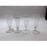 Four 19th Century ale glasses, all with wrythen decoration to the tapering bowls, largest 5.5"